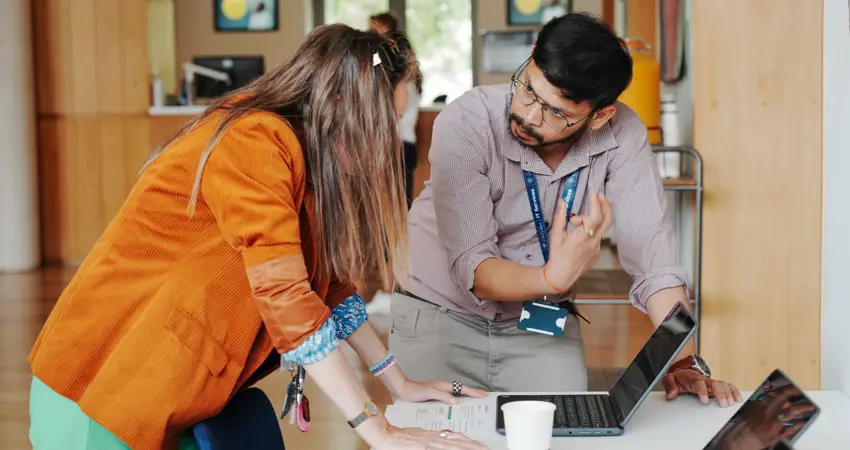 Colleagues chatting at the AI Knowledge Exchange Forum